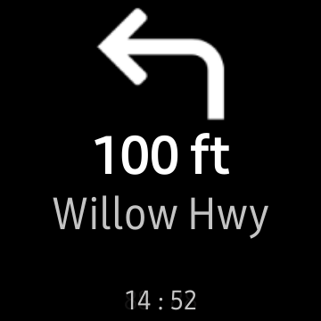 Una dirección "Awesome Navigator" en la pantalla de un reloj inteligente Samsung para girar a la izquierda en "Willow Hwy" en "100 pies". 