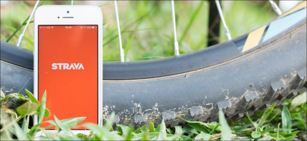 La aplicación Strava en un teléfono inteligente junto a un neumático de bicicleta.